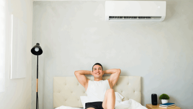 a man enjoying the climate in a room controlled by a ductless mini split ac unit