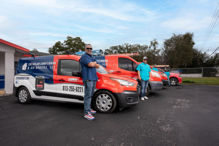 Heating Installation 7 Custom Air Conditioning Air Quality team members stand proudly beside their branded service vans parked outside the companys office ready for AC repair and service calls 768x512 1