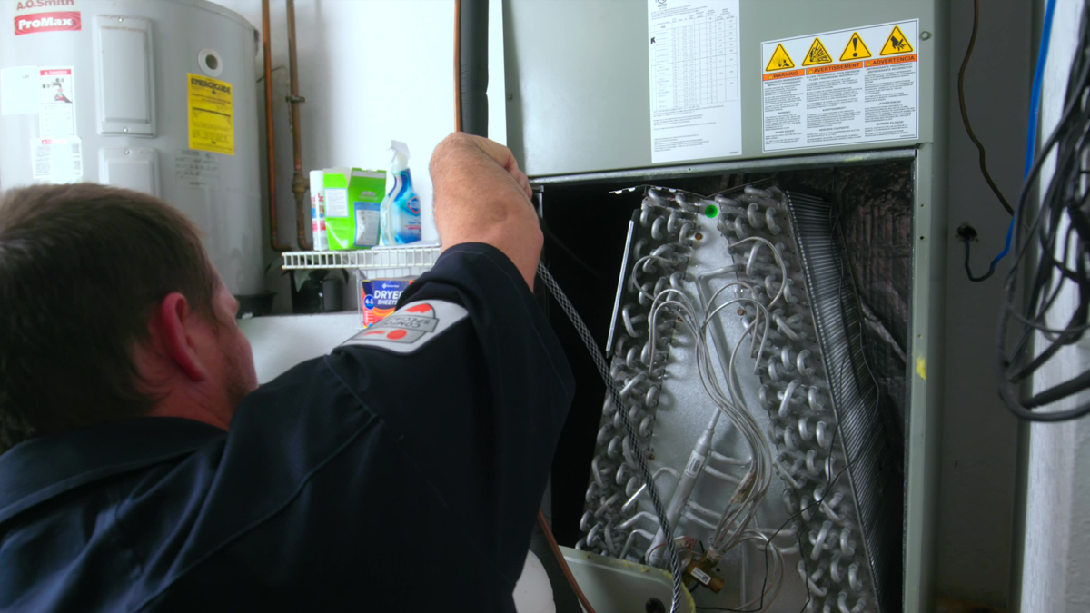 Custom air conditioning and air quality technician testing HVAC system functionality