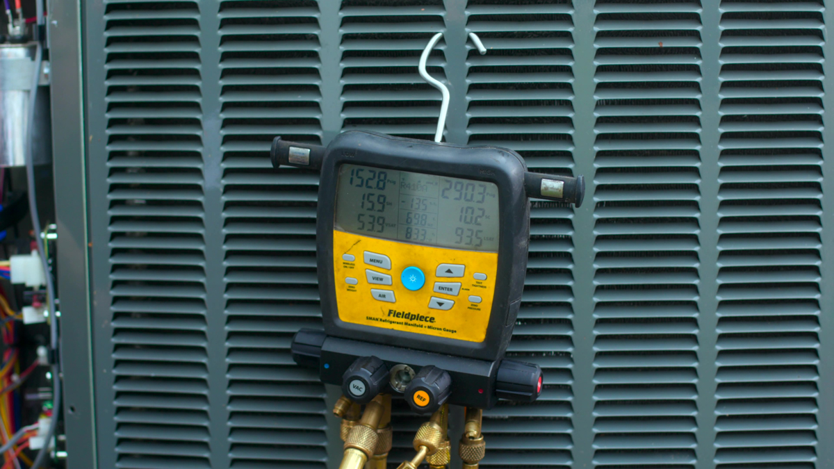 Custom air conditioning and air quality technician testing HVAC system