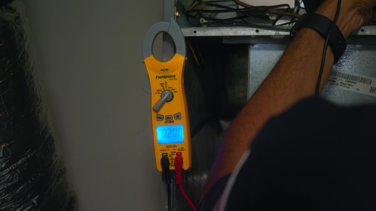 Custom air conditioning and air quality technician working with testing tools