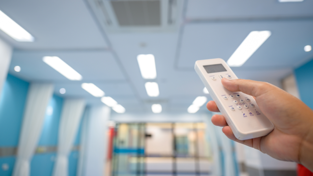 Healthcare HVACs: Ensuring Clean and Efficient Airflow in Medical Facilities 2 a healthcare worker using a smart remote to control the hvac system 1024x576 1