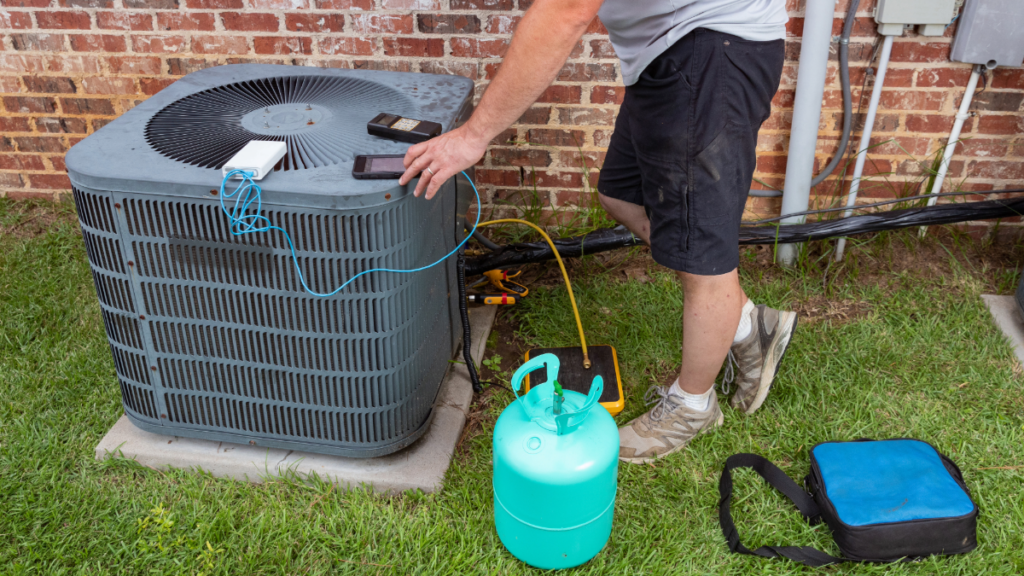 Why HVAC Maintenance Services Are Essential in Pasco County in 2025 2 an ac technician charging an ac units refrigerant 1024x576 1